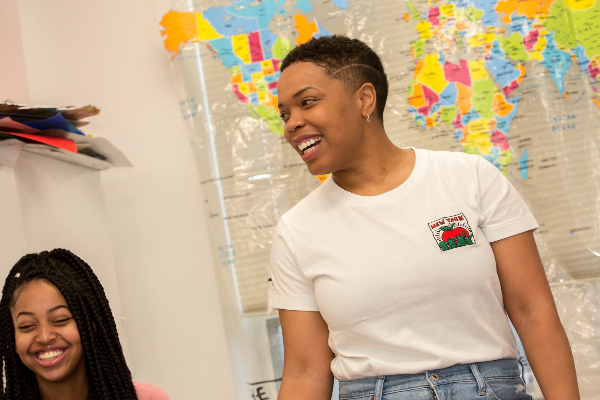 Teacher smiling in front of student.