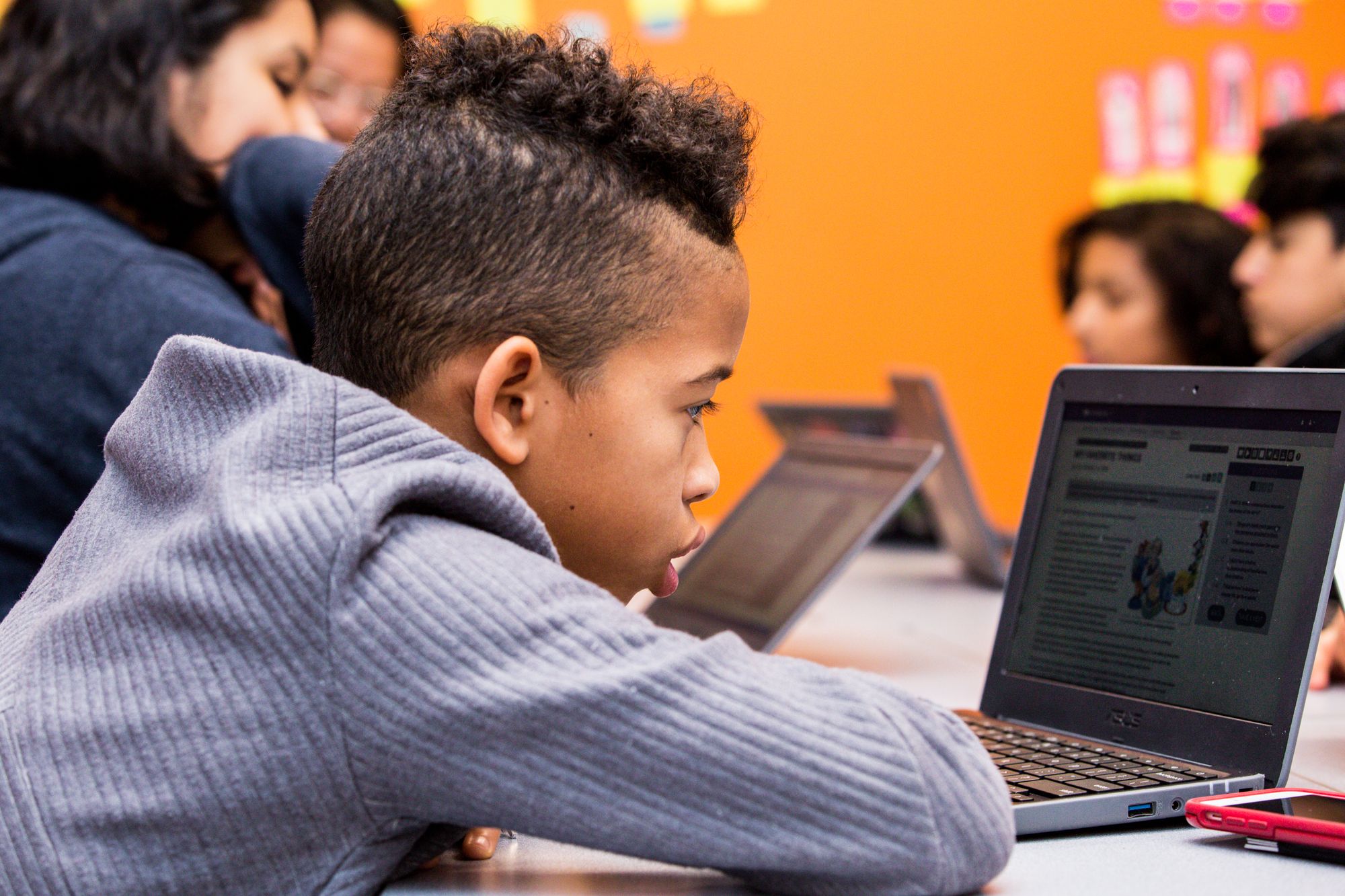 Student looks at CommonLit lesson on laptop