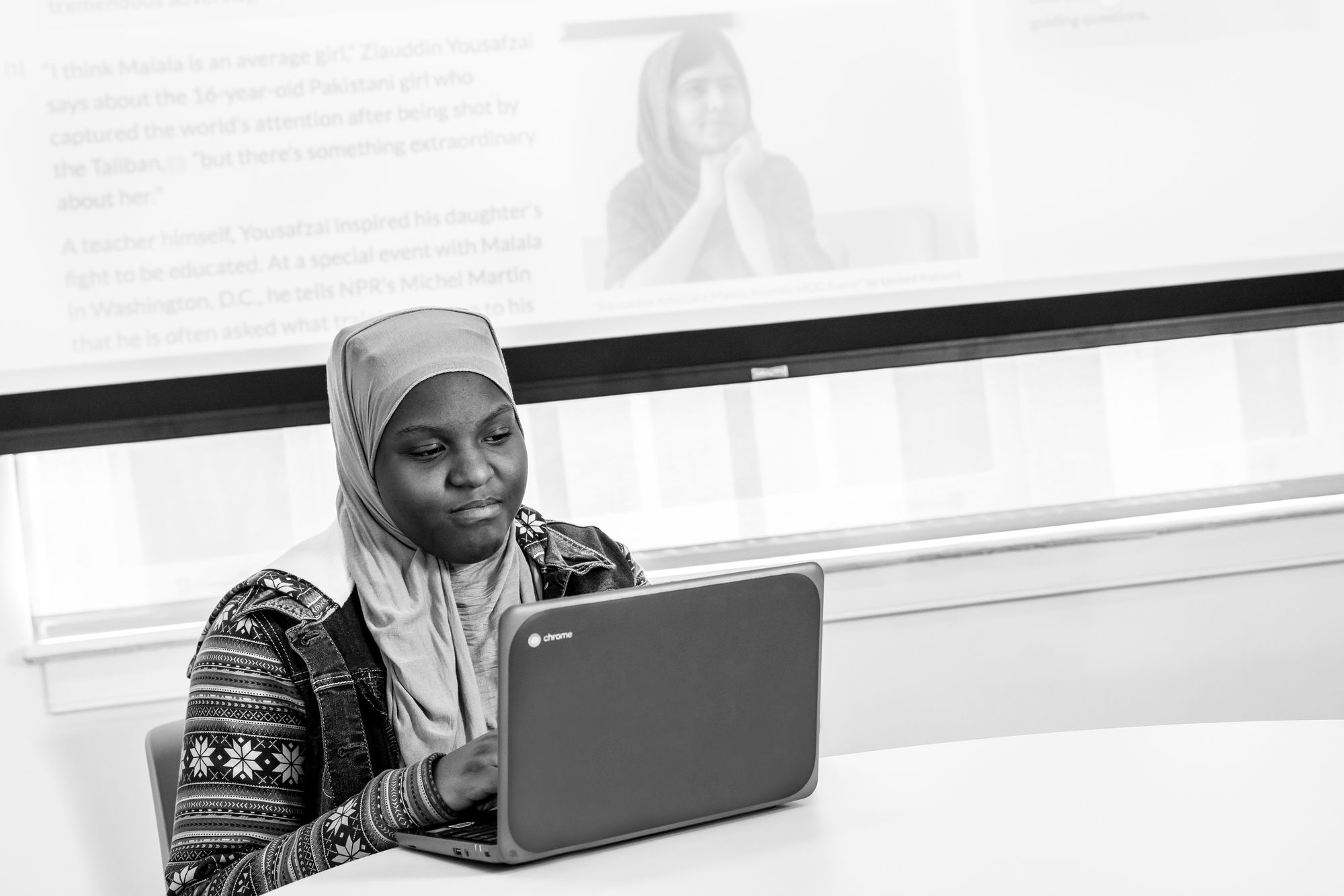 A student works at a computer independently.