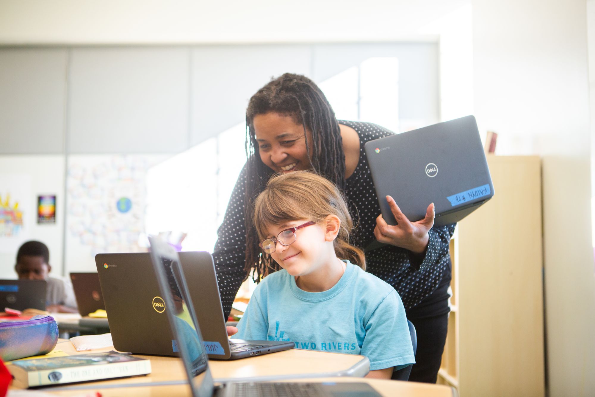 A teacher and student work together.