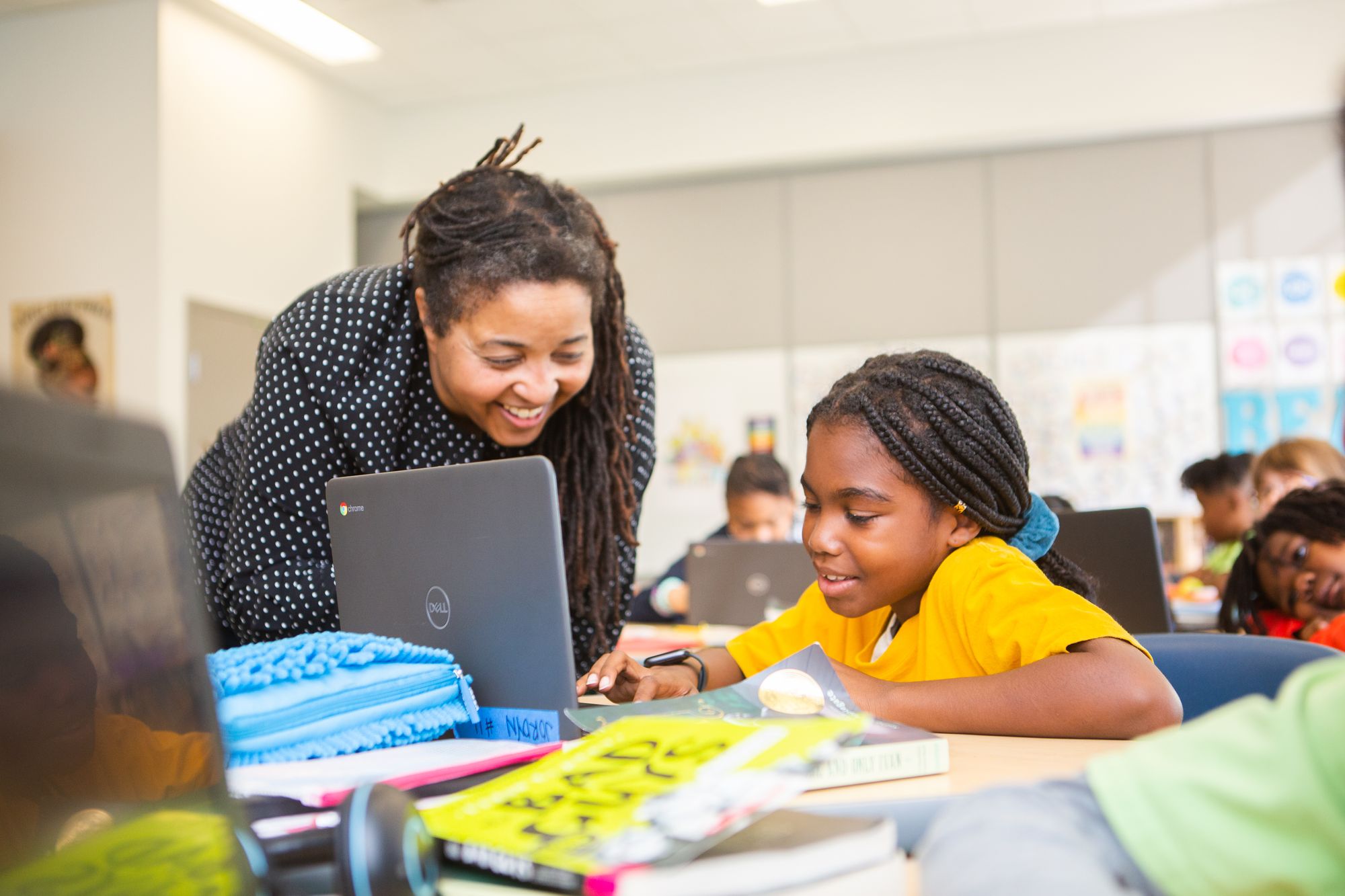 A teacher works with a student.