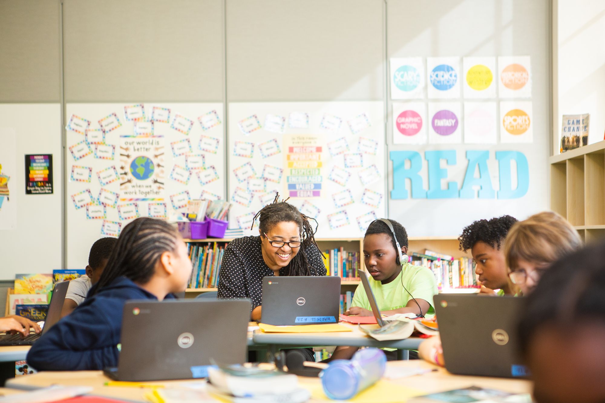 Students and teacher are in a classroom reading an engaging, diverse story from the CommonLit website. 