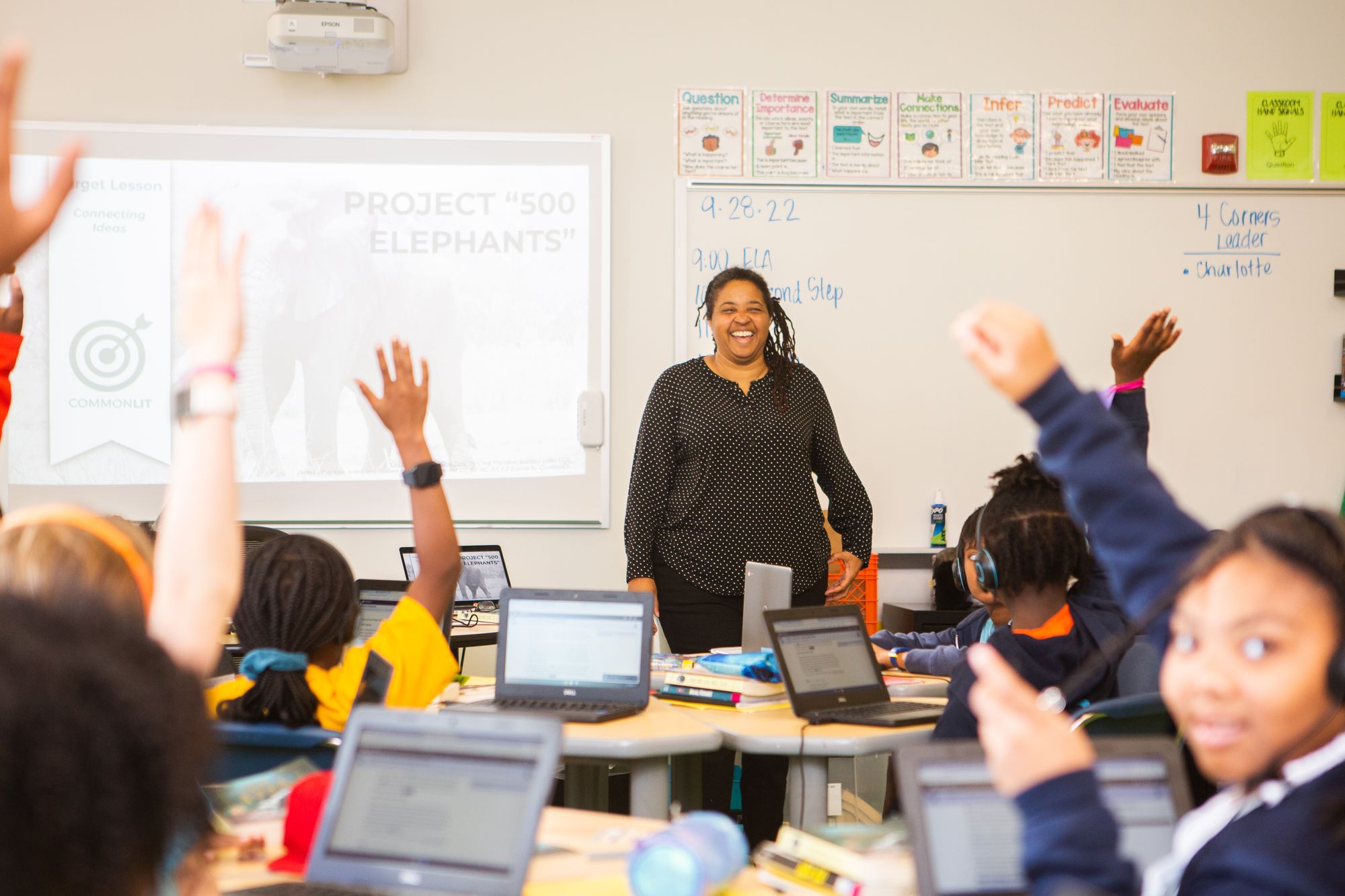 Students raise their hands during a CommonLit lesson