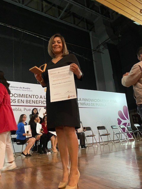 Docente recibiendo premio