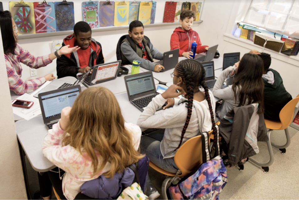 Teacher and students talk during class.